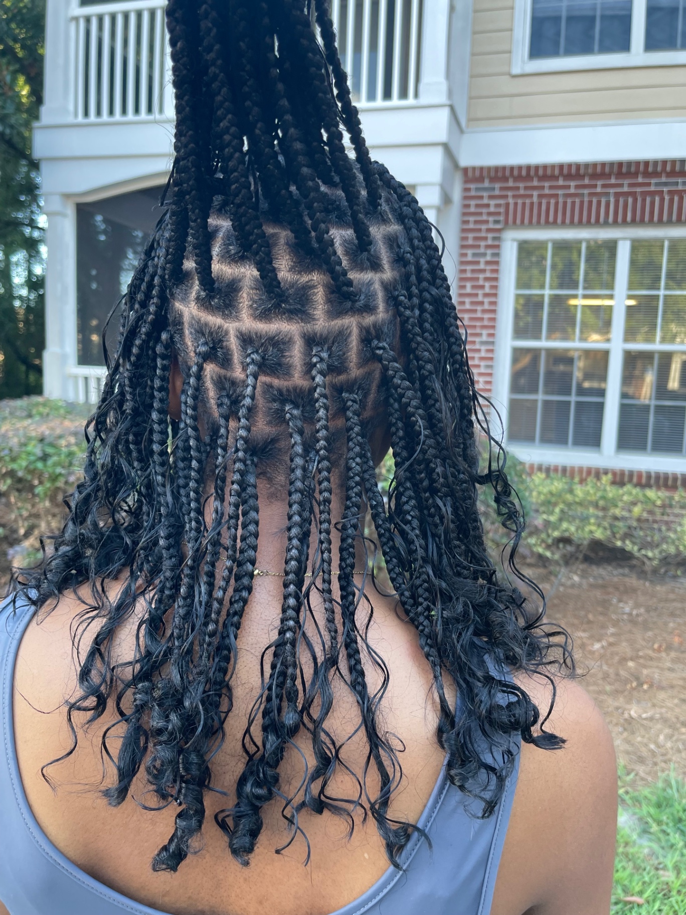 Long knotless braids with curled ends, back view