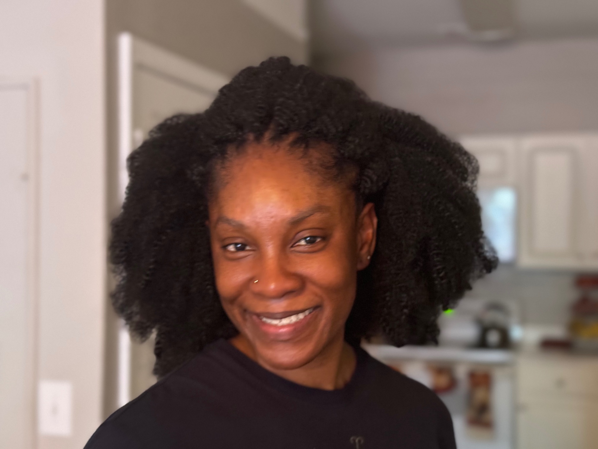 Client wearing a full twist-out natural hairstyle