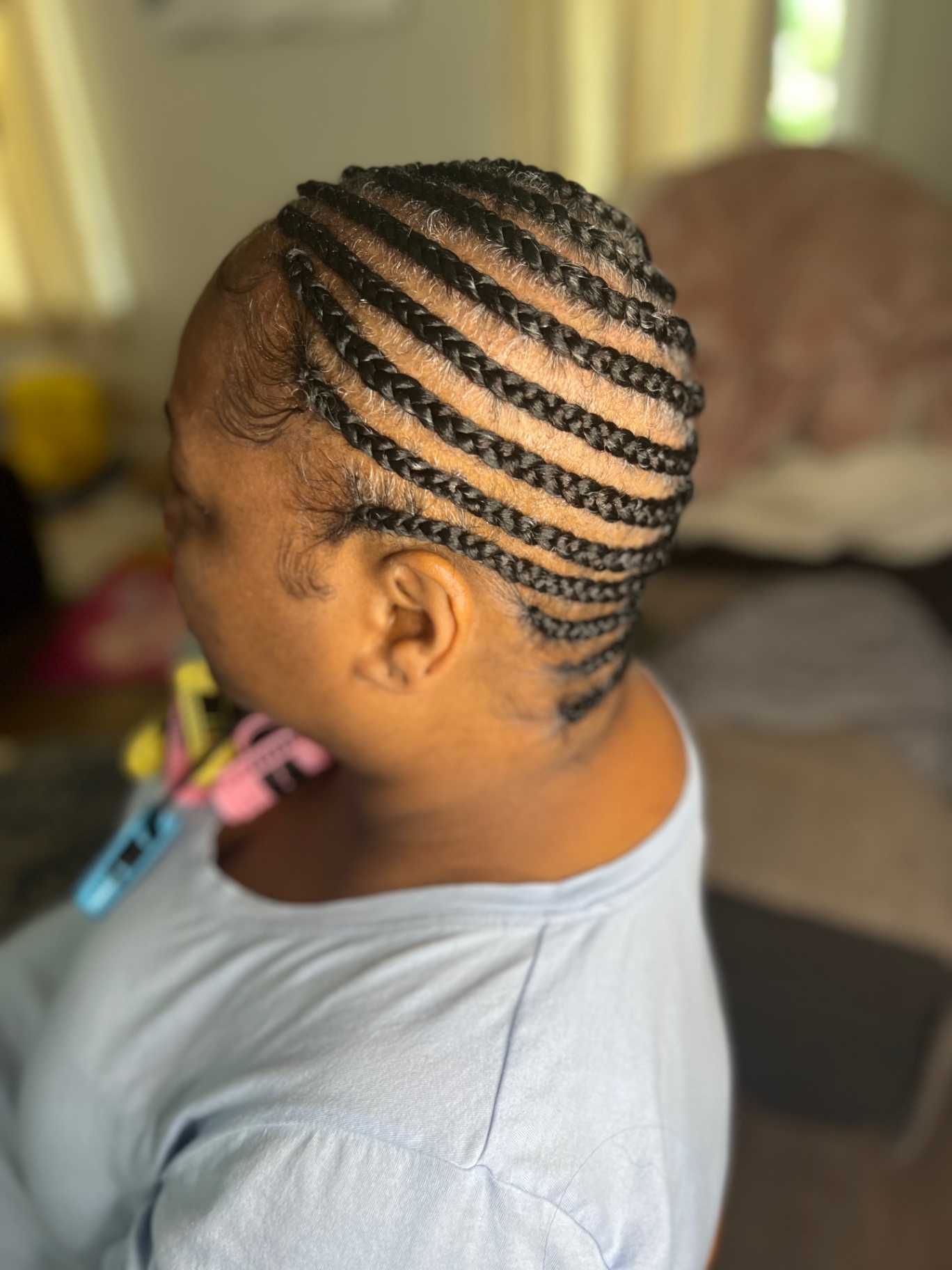 Neat straight-back cornrows on natural hair