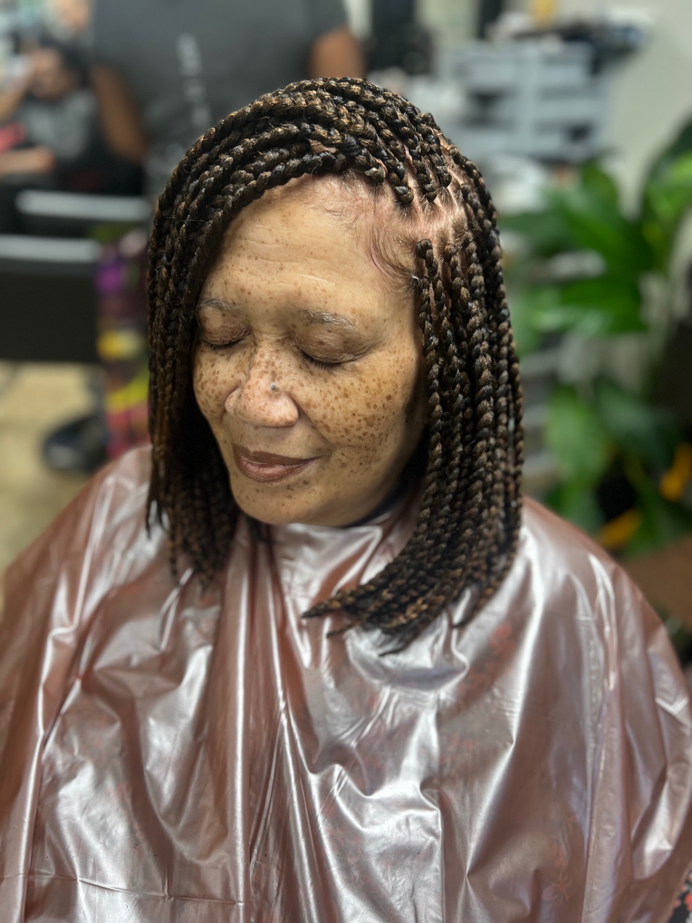 Shoulder-length braided bob in warm honey tones