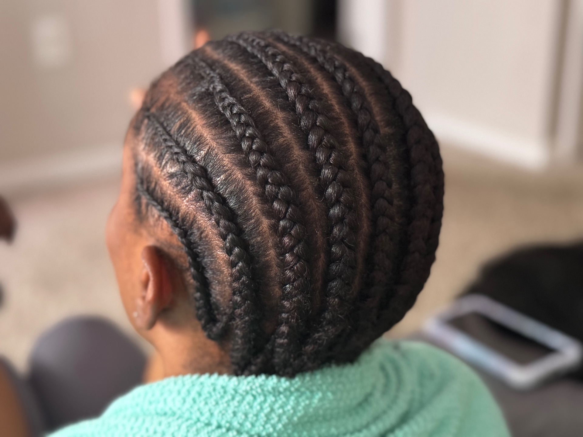 Neat straight-back cornrows on natural hair